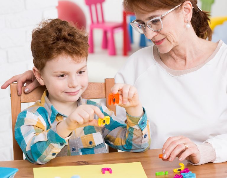 Squared photo of occupational therapist and little boy